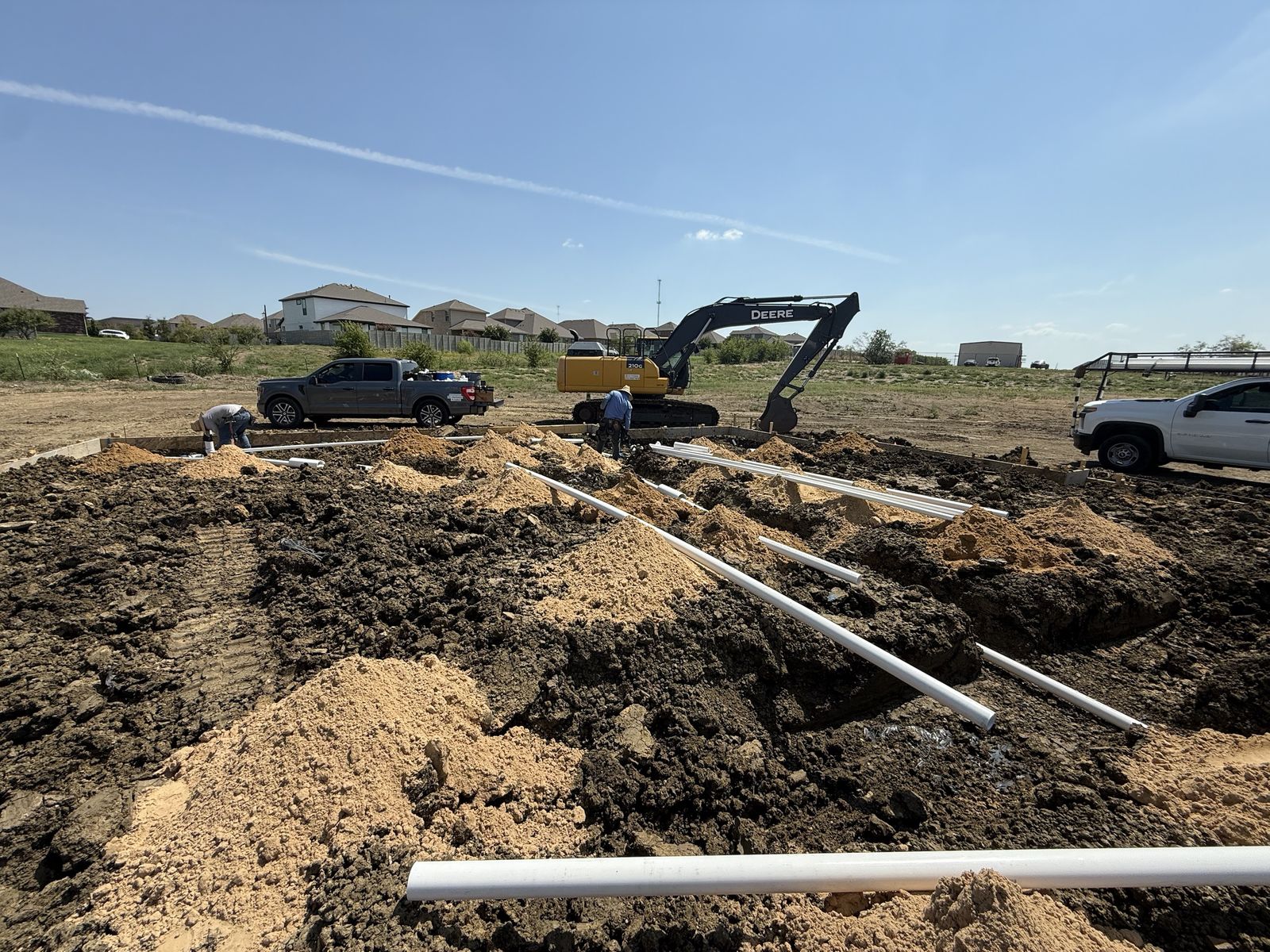 Under-slab plumbing being installed on a Sandlin Signature homesite